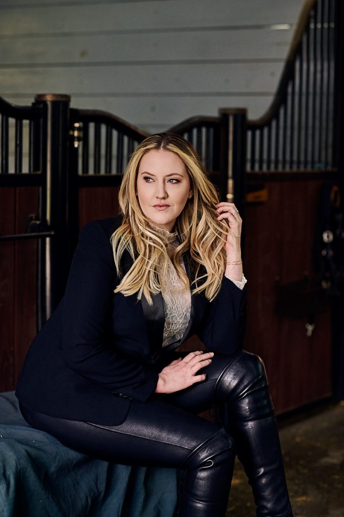 Branding portrait of a woman in a blazer photographed in a horse barn, Ocala Florida