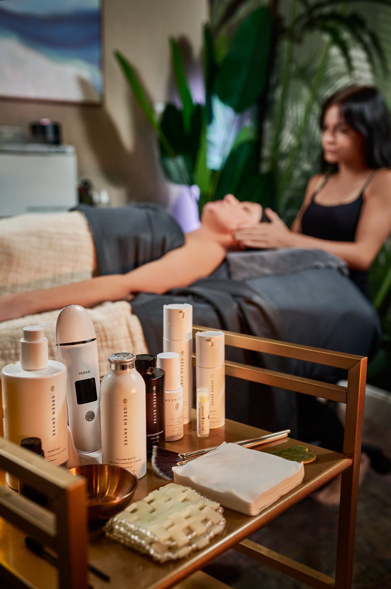 Organic skincare products displayed beside a facial treatment at Nurtured Wellness